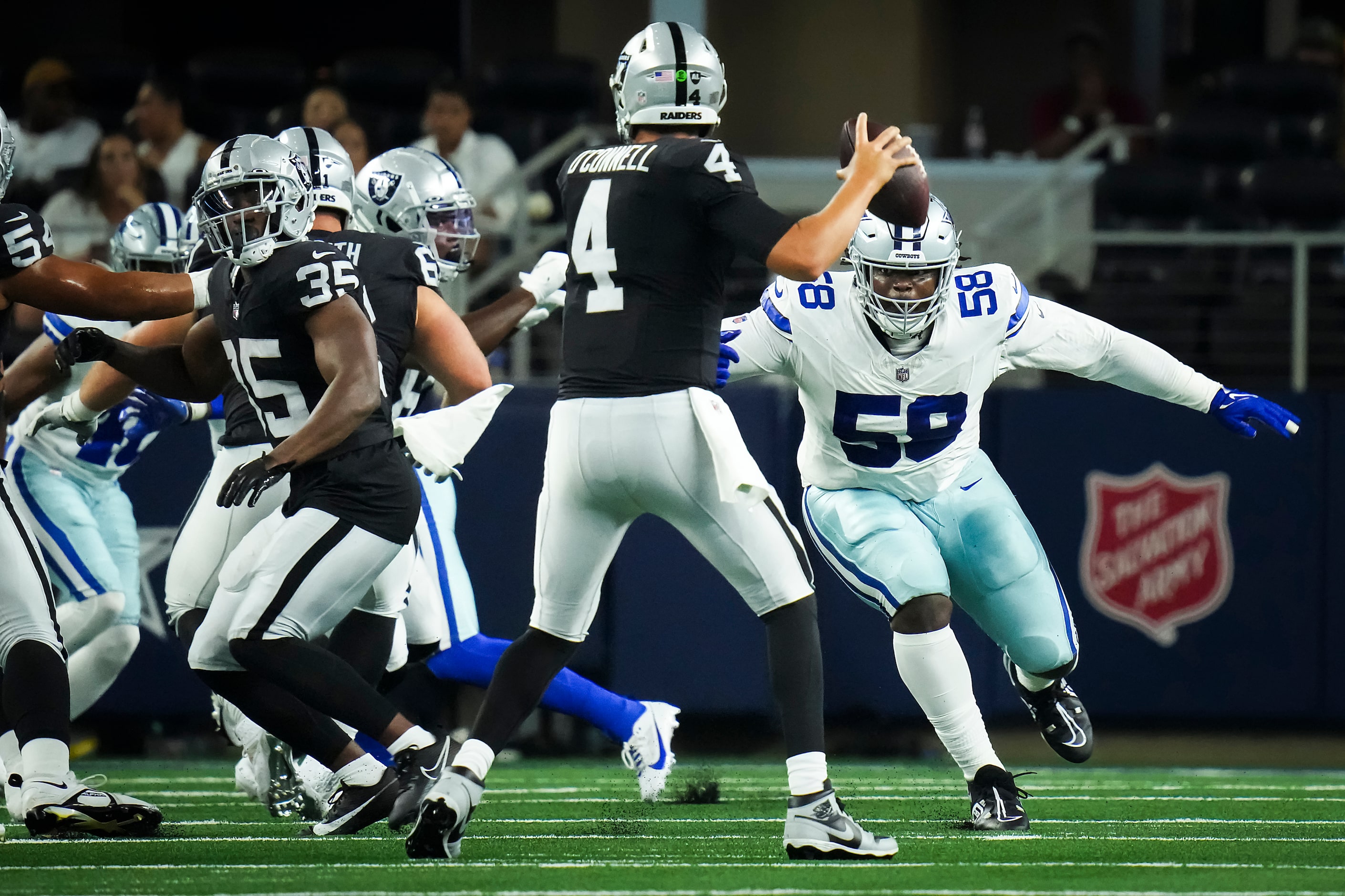 Las Vegas Raiders quarterback Aidan O'Connell (4) throws a pass under pressure from Dallas...