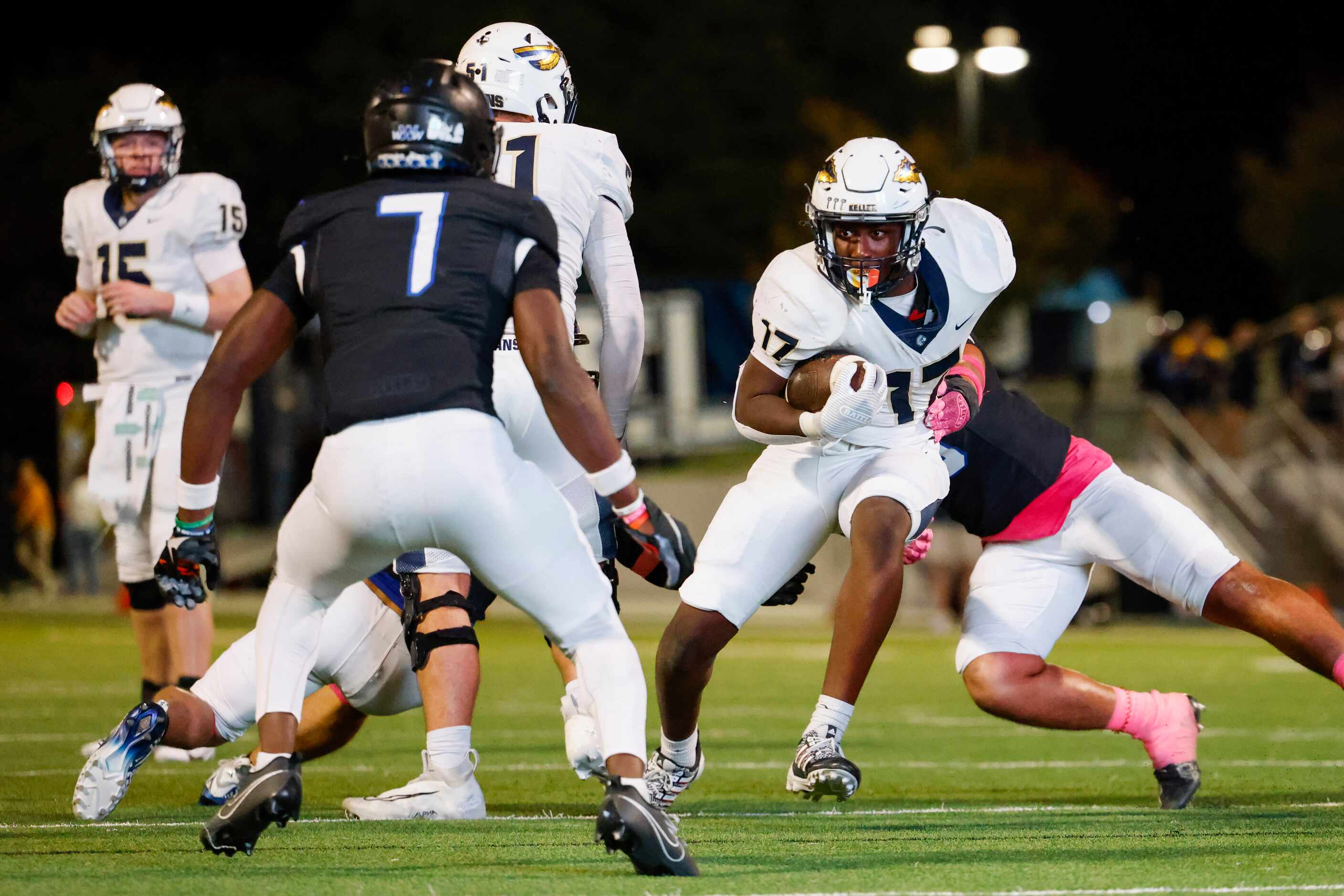 Keller High’s Kaleb Malzac (right) runs with the ball to the end zone during the second half...