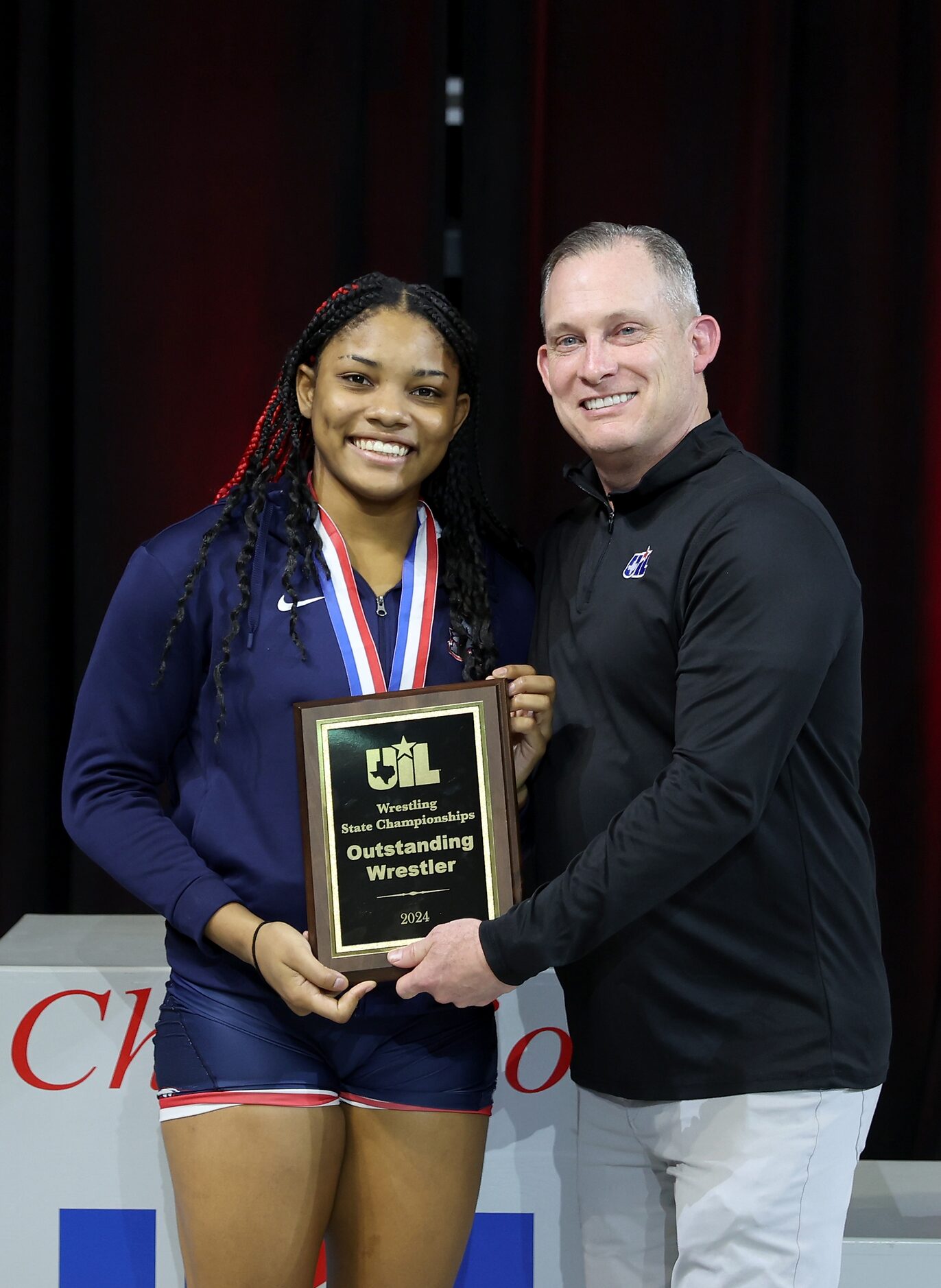 Jasmine Robinson of Allen is awarded the Outstanding Wrestler Award in the 6A girls division...