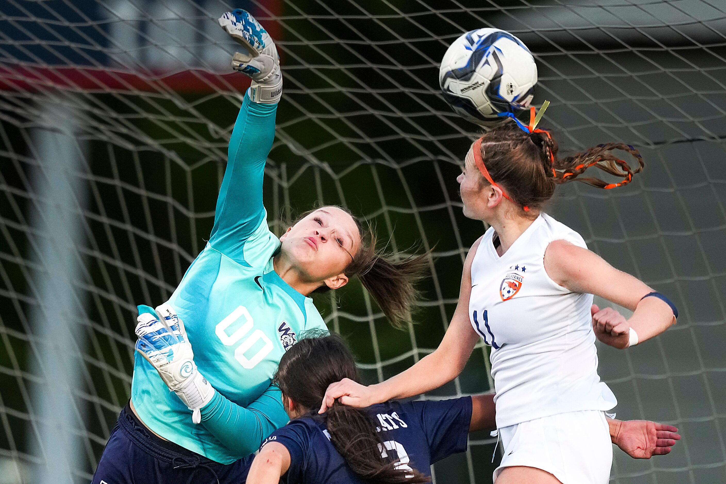 Prosper Walnut Grove goalkeeper Finley Pike punches a cross away from Frisco Wakeland’s  LG...