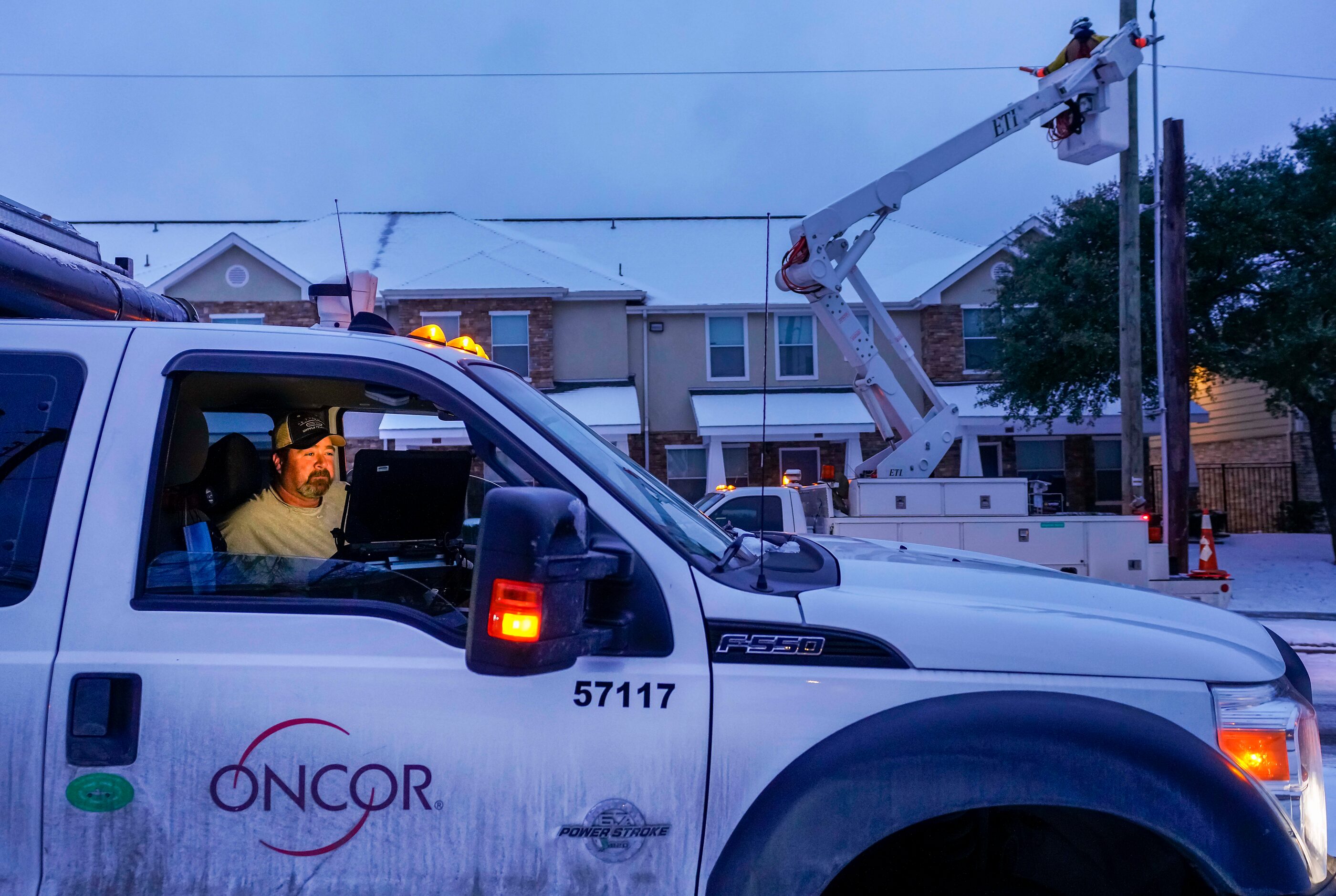 An Oncor crew works on along Elsie Faye Higgins Street as power outages continue across the...