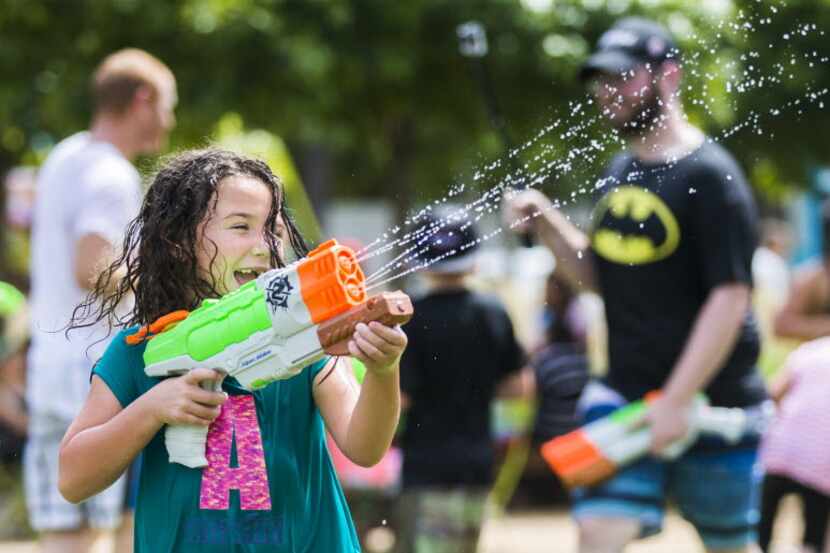Avyn Hughes, 5, of Rockwall, Texas participates in a massive water gun fight hosted by...