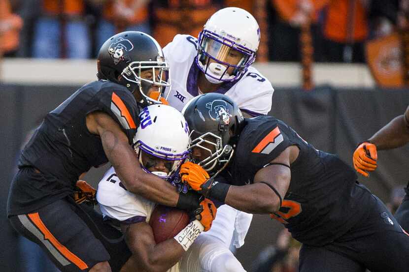 TCU wide receiver KaVontae Turpin (25( is brought down by the Oklahoma State defense during...