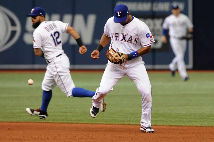 Texas Rangers second baseman Rougned Odor (12) and shortstop Elvis Andrus come up short on...