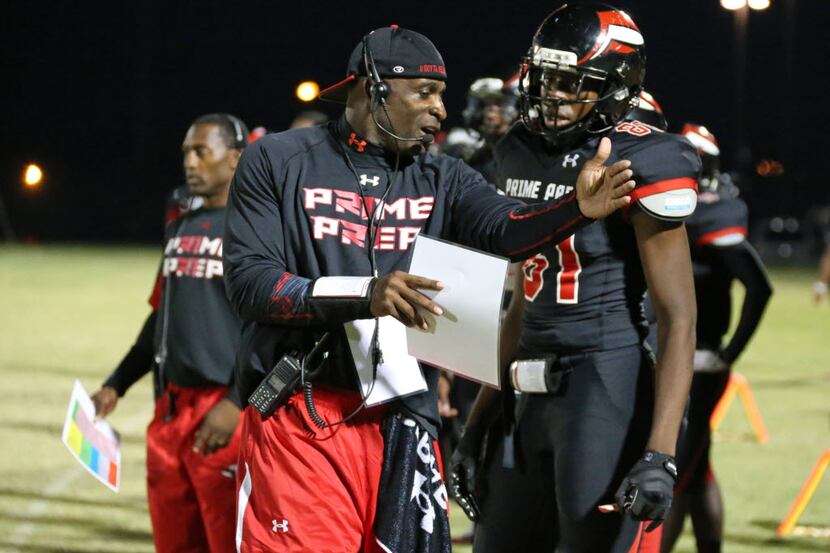 Prime Prep co-founder and coach Deion Sanders talks with receiver Caleb Chumbia (81) during...