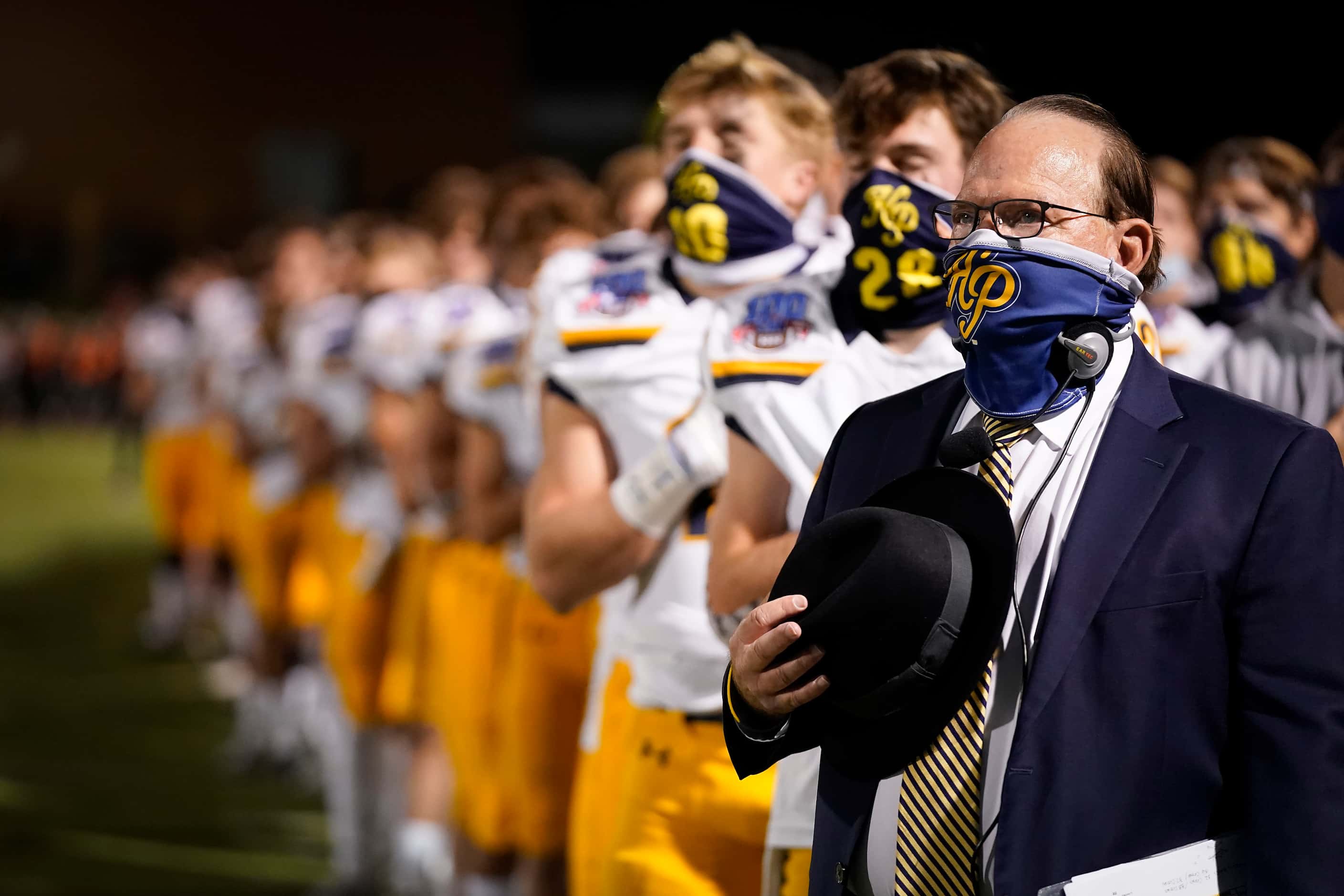 Highland Park head coach Randy Allen stands with his team for the national anthem before a...