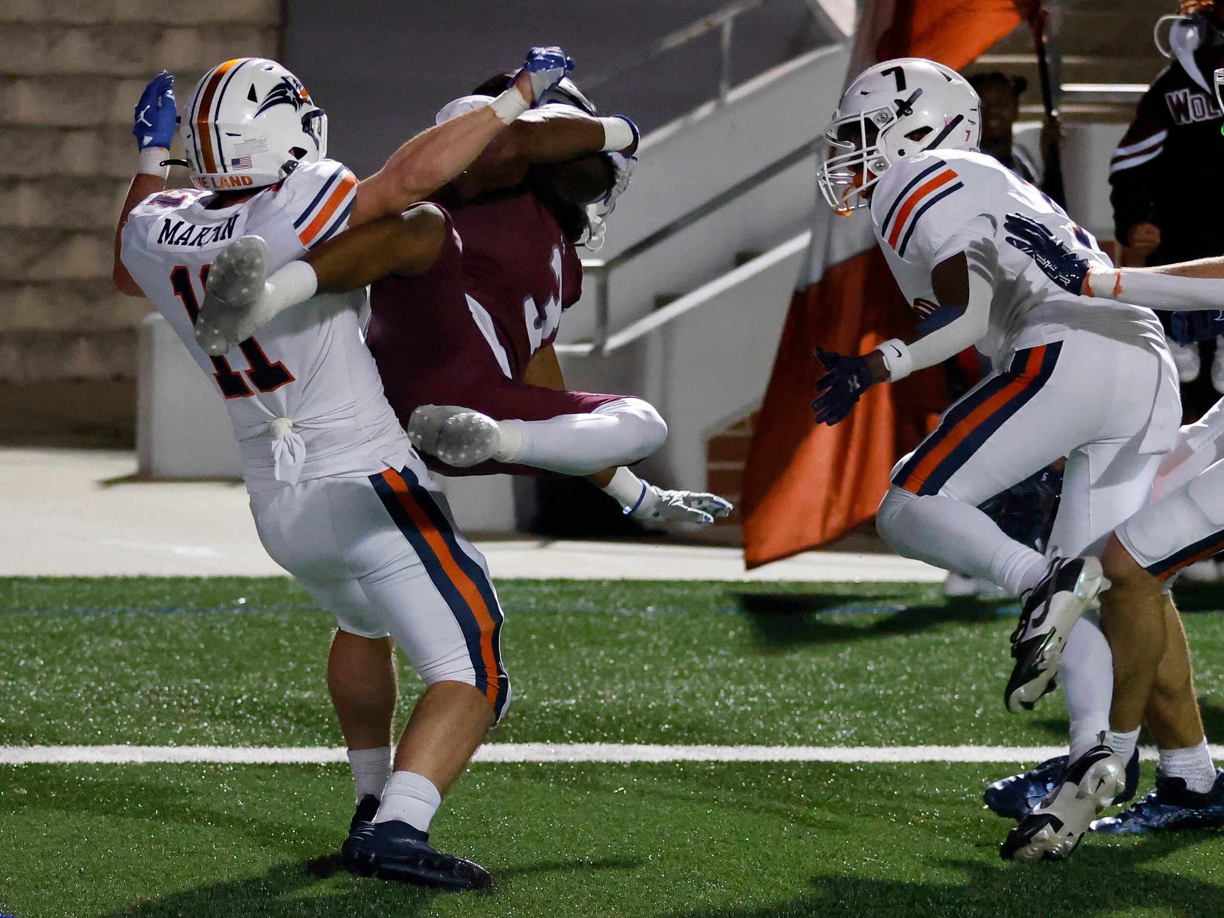 In the back of the end zone, Mansfield Timberview wide receiver Cameron Bates (3) comes down...