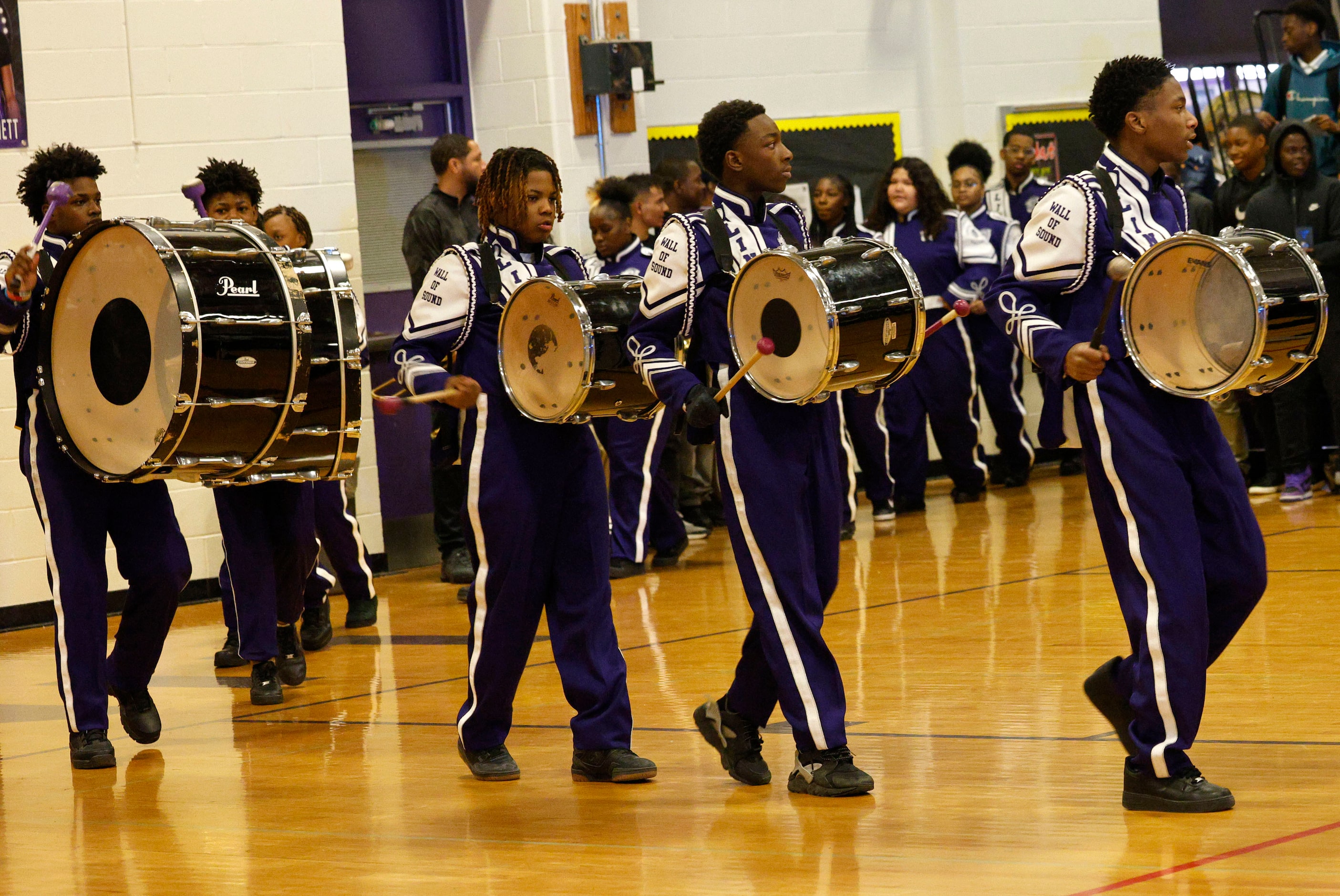 Lincoln High School marching band members perform during a send-off event for their girls...