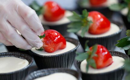 Marissa Lopez makes strawberry cheesecakes at the new Carlo's Bakery store at Stonebriar...