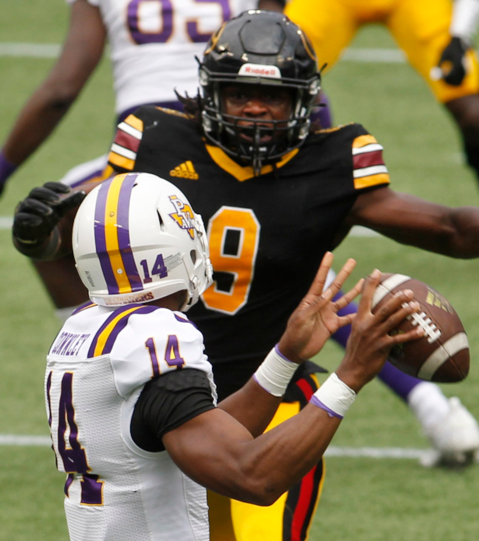 Prairie View A&M quarterback Trazon Connley (14) narrowly avoids the defensive pressure of...