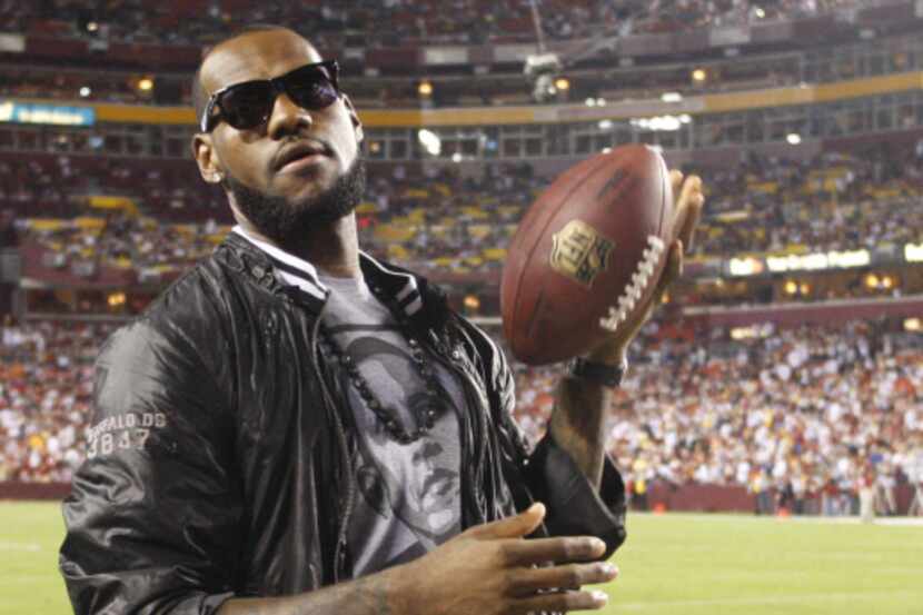 LeBron James stands on the sidelines before the Dallas Cowboys play the Washington Redskins...