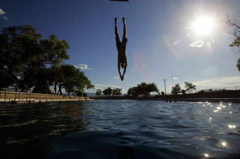 A swimmer dives into the spring-fed swimming pool at Balmorhea State Park in Toyahvale, Texas.