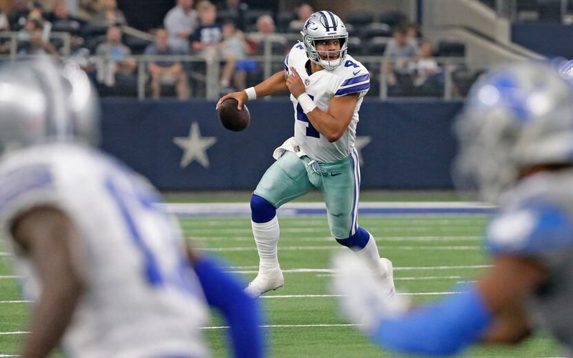Dallas Cowboys quarterback Dak Prescott (4) scrambles out of the pocket as he looks for a...