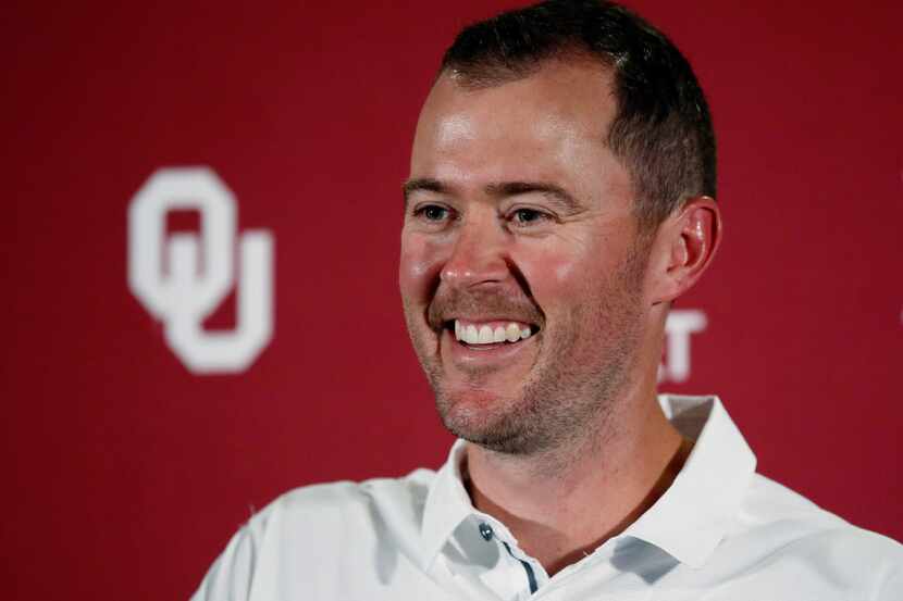 Oklahoma head coach Lincoln Riley smiles as he answers a question during an NCAA college...