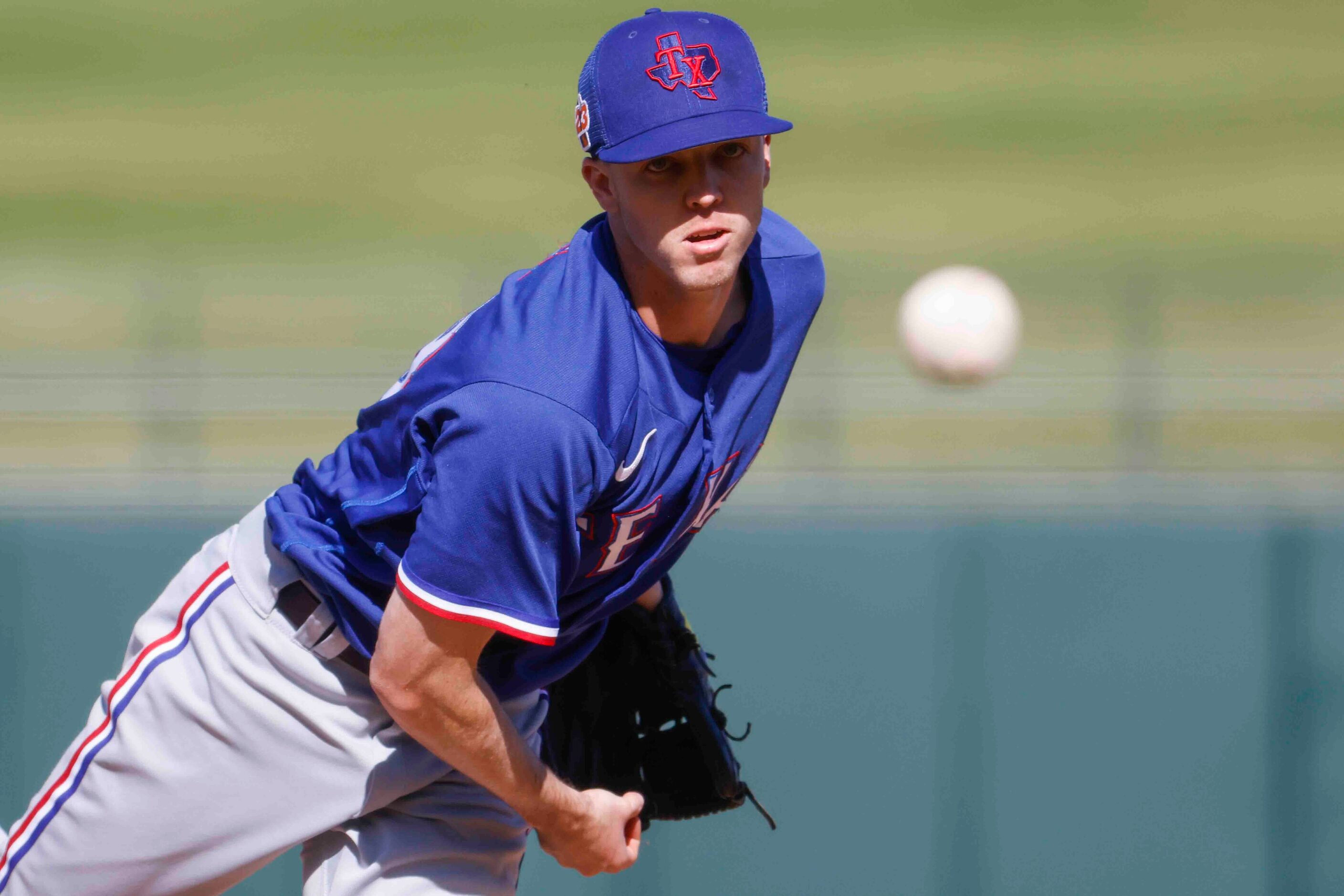 Texas Rangers Chase Lee throws a pitch during the seventh inning of a spring training game...