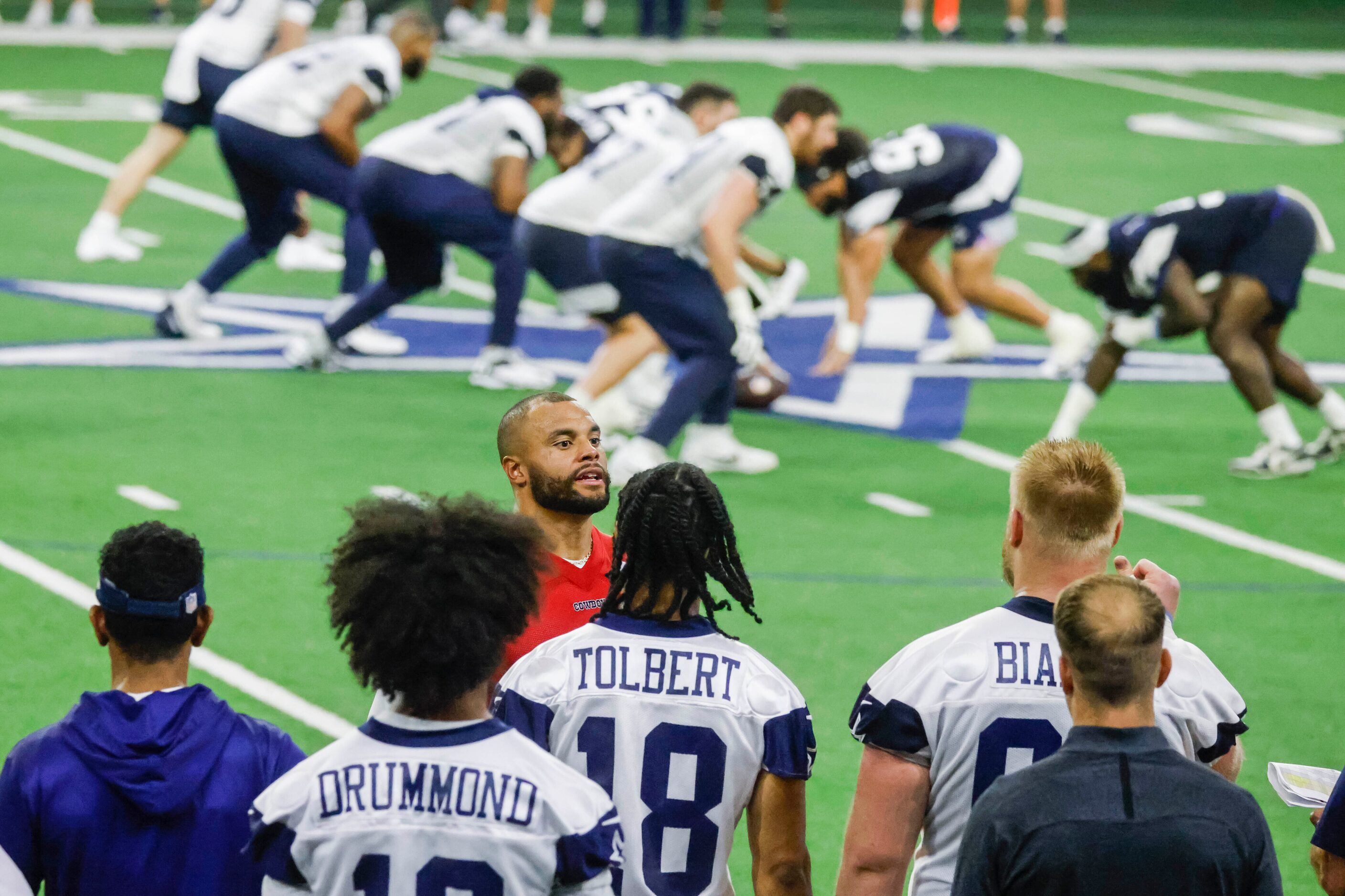 Dallas Cowboys quarterback Dak Prescott talks to the players in the sideline during OTA...