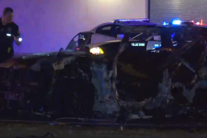 A Dallas police officer investigates the crash, which involved a Range Rover and Chevy Tahoe.