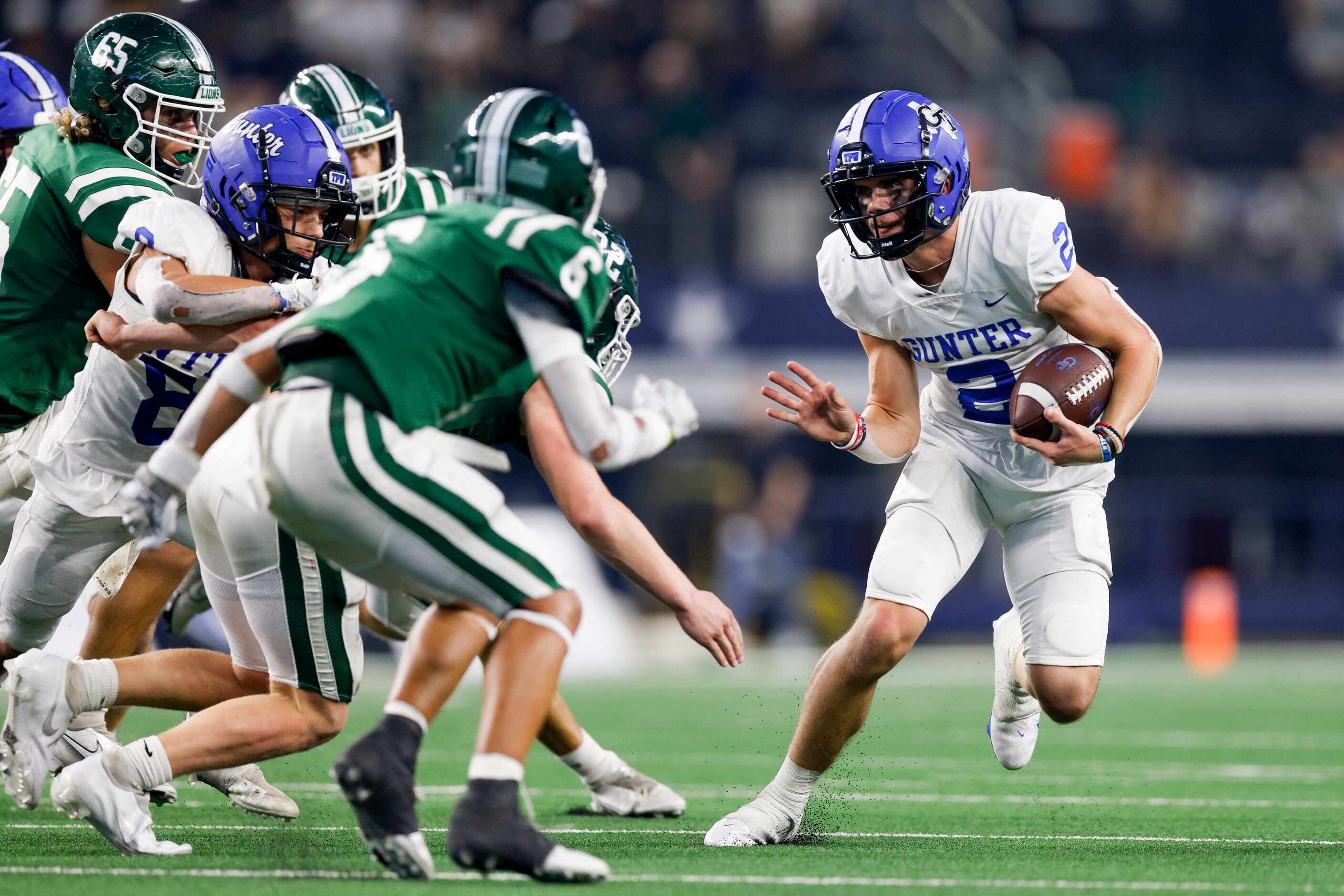Gunter quarterback Hudson Graham (2) cuts outside to avoid the Franklin defense during the...