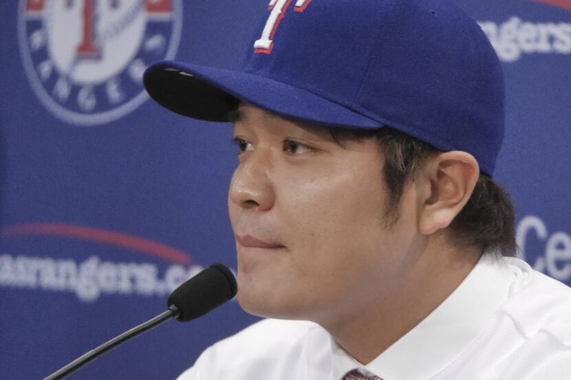 Texas Rangers Shin-Soo Choo listens to a question from the Korean media at a press...