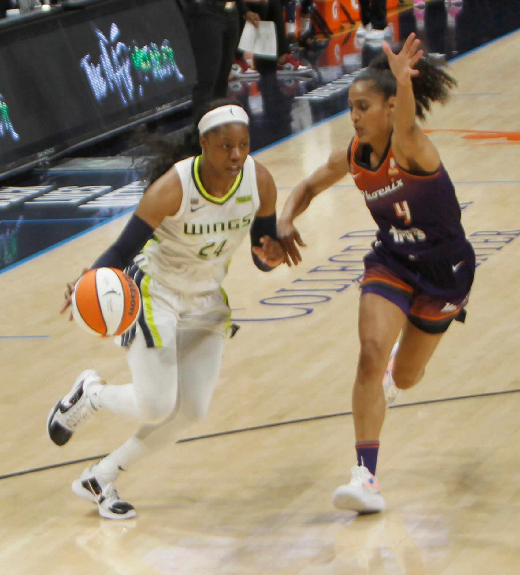 Dallas guard Arike Ogunbowale (24) drives to the basket as she is defended by Phoenix guard...