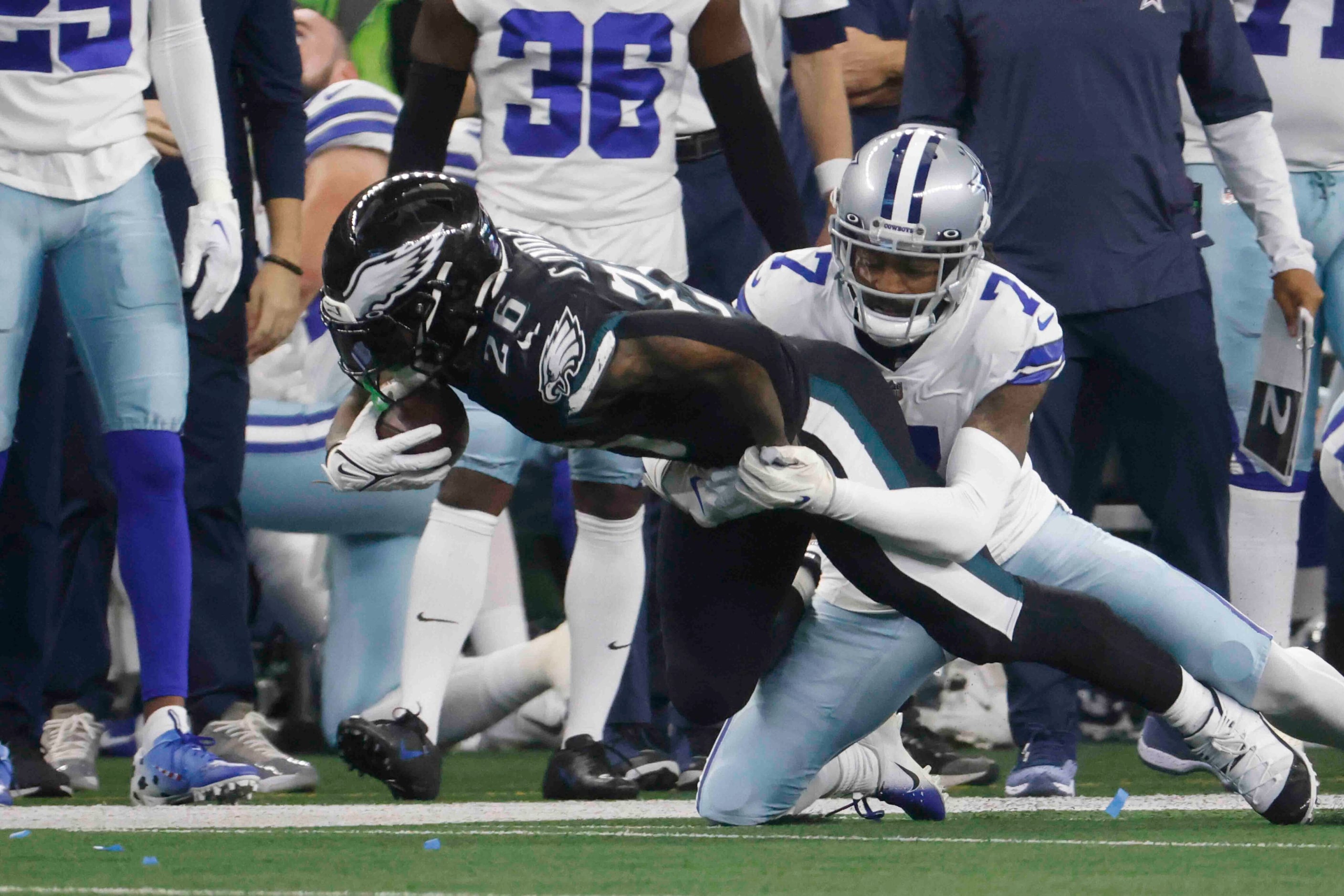 Dallas Cowboys cornerback Trevon Diggs (7), right, tackles, Philadelphia Eagles running back...