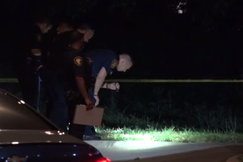 Fort Worth police investigate the crime scene where a man was found shot in the driveway of...