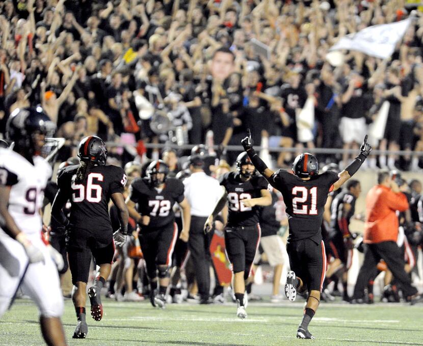 Coppell's Jacob Logan (21) and teammates celebrate after their second quarter touchdown...