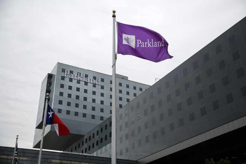 The Texas and Parkland flags fly outside the new 17-story, $1.3 billion Parkland Memorial...