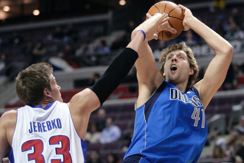 Dallas Mavericks' Dirk Nowitzki (41) takes a shot over Detroit Pistons' Jonas Jerebko (33)...