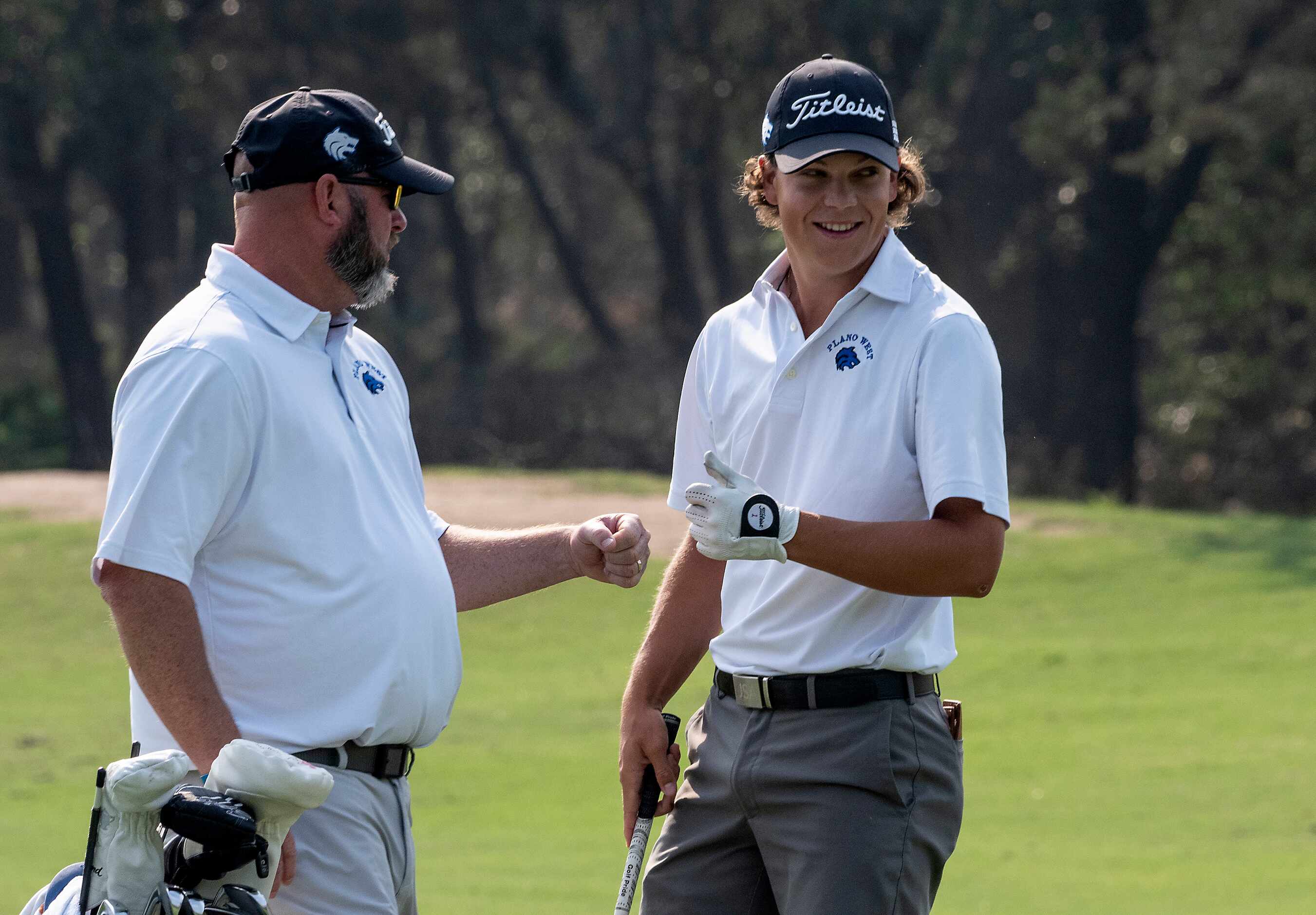 Plano West, Matt Comegys gets a fist bump from head coach, Joe Cravens, let, after his...