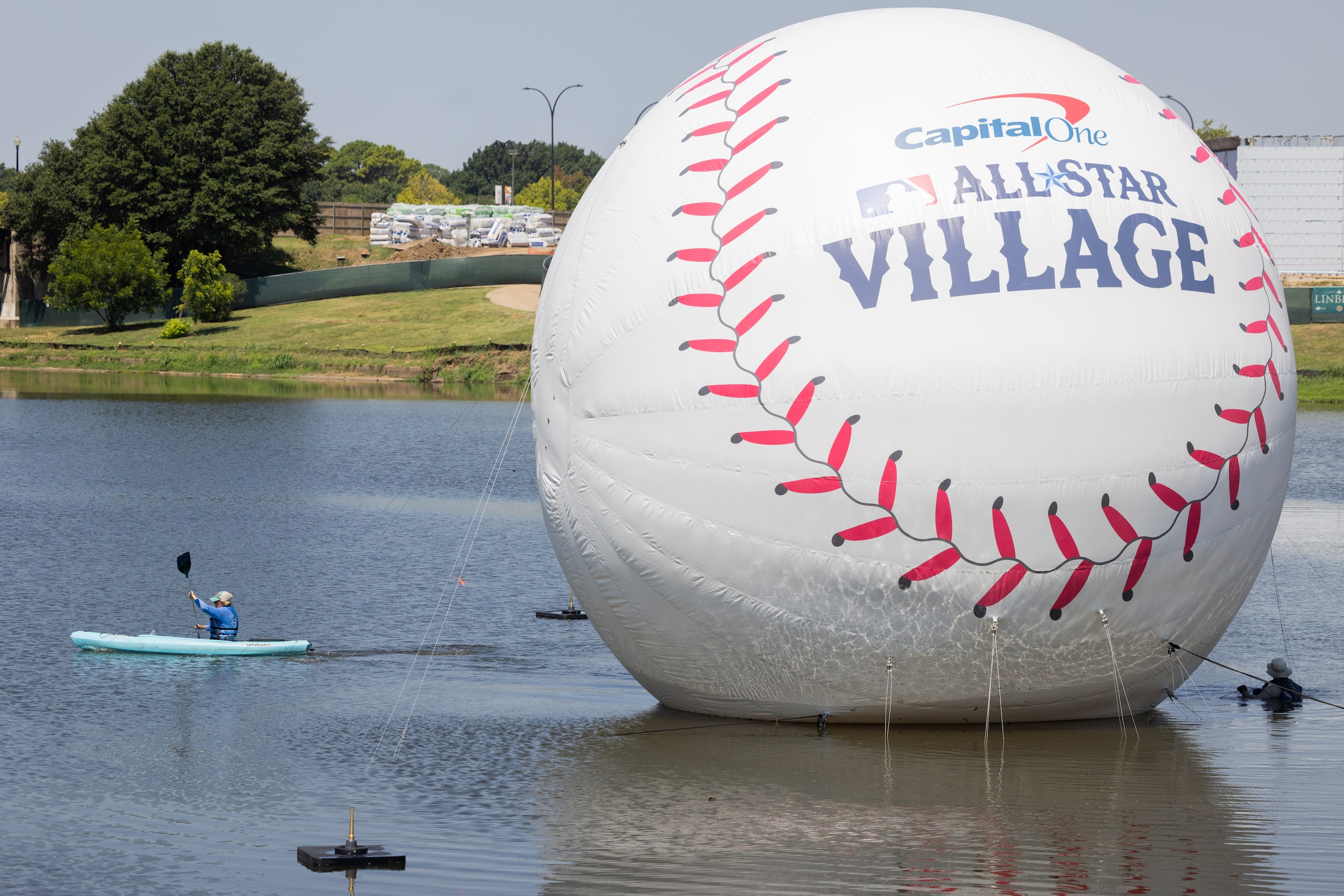 A floating baseball on display on Mark Holtz Lake at MLB's All-Star Village in Arlington on...