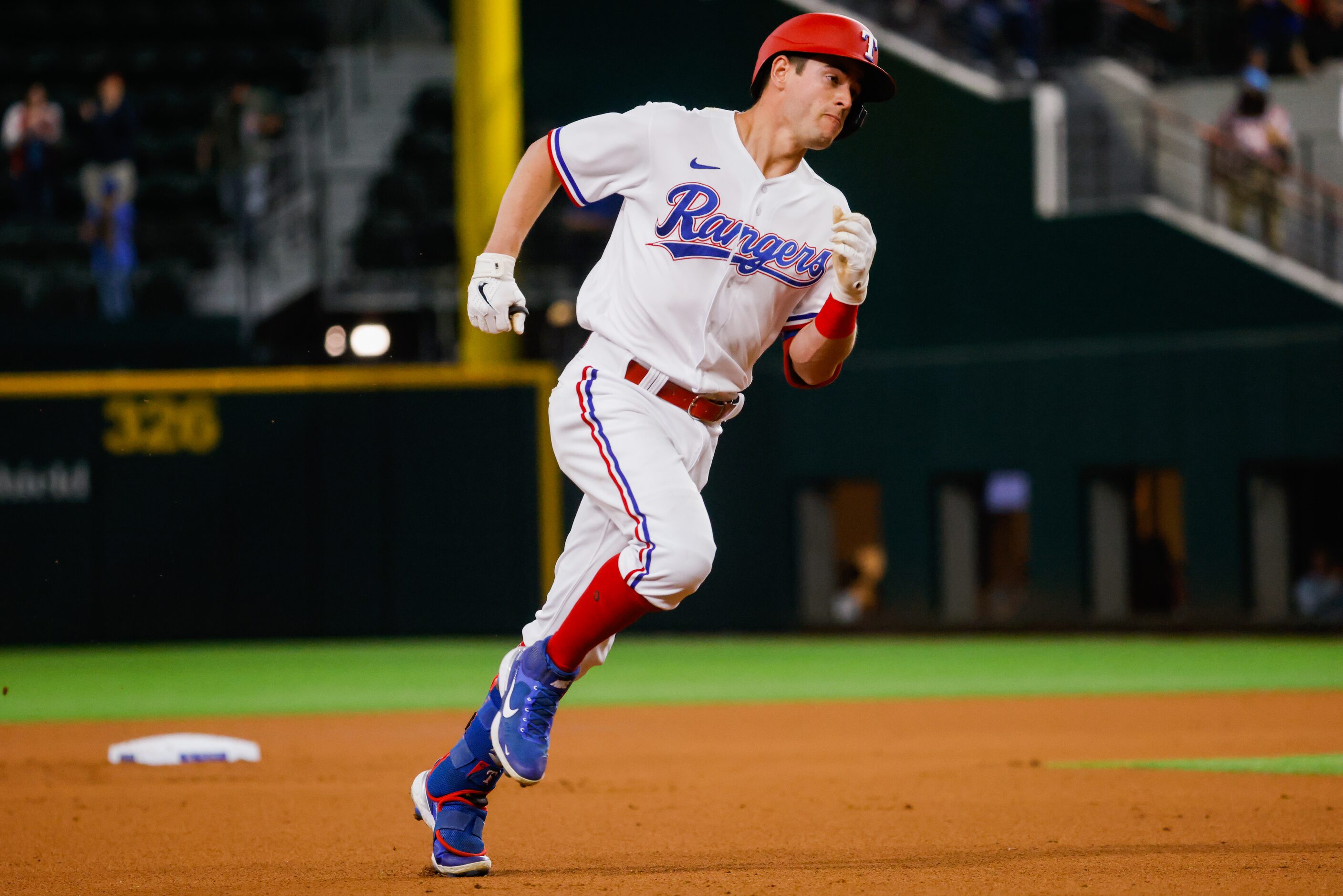 Texas Rangers second baseman Nick Solak (15) runs to third base after hitting a homer on a...