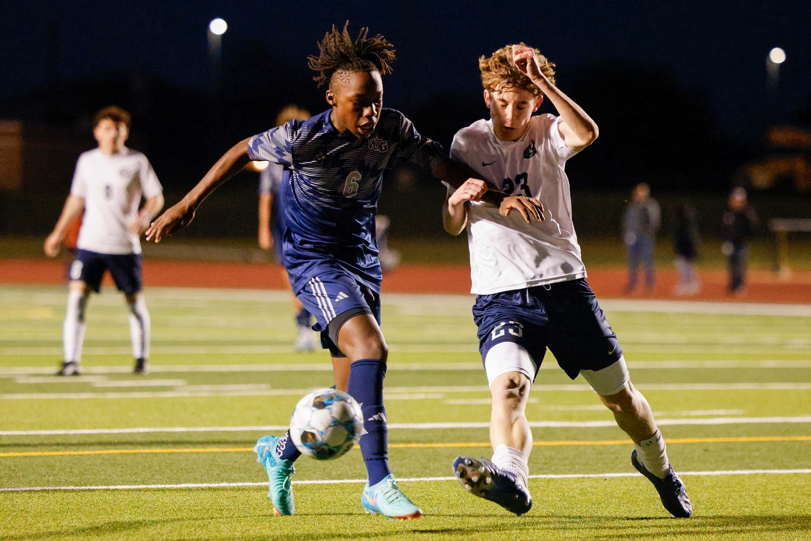 Frisco Reedy's Donovan Schmidt (23) tackles the ball away from Prosper Walnut Grove defender...