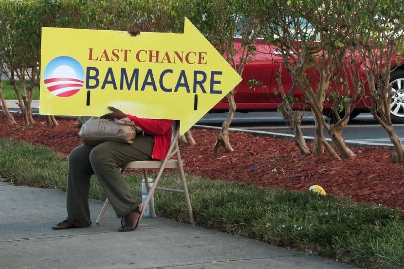 (FILES) This file photo taken on November 27, 2016 shows a woman holding an Obama Care sign...
