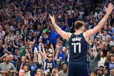 Dallas Mavericks fans celebrate a basket by guard Luka Doncic during the second half in Game...