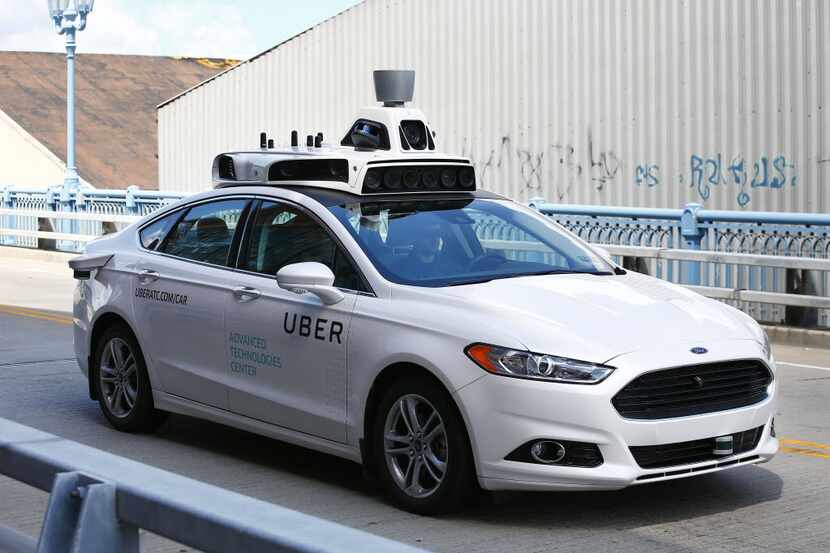 A self-driving Ford Fusion hybrid car is test driven, Thursday, Aug. 18, 2016, in...
