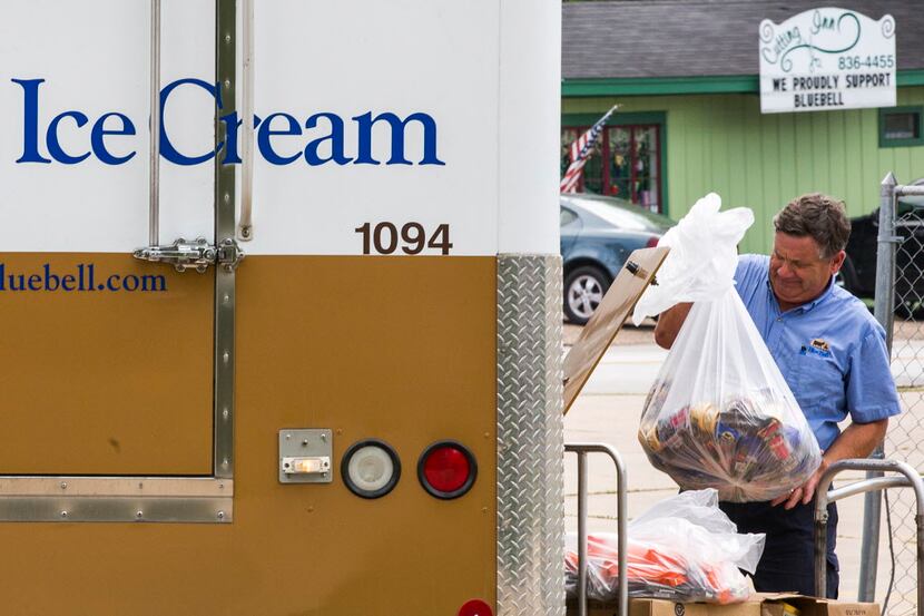  A Blue Bell Creameries employee loads recalled ice cream into a truck after picking it up...