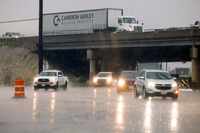 Drivers travel through heavy rain at Jupiter Road and the I-635 service road, Tuesday, May...