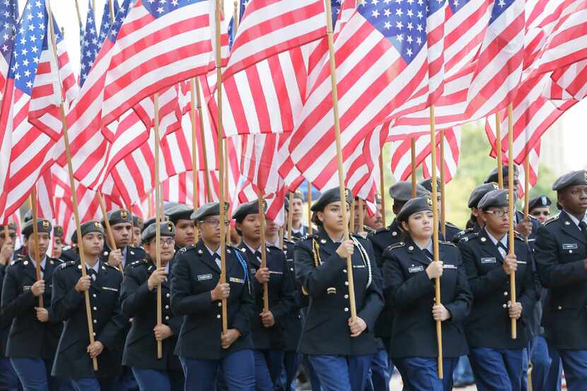 Irving High School ROTC members carry flags during a Veteran's Day parade in Dallas, Friday,...