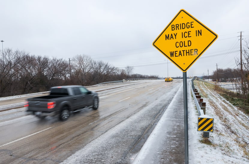 Cars drive across an icy bridge over Northwest Highway on Skillman Street in Dallas on...