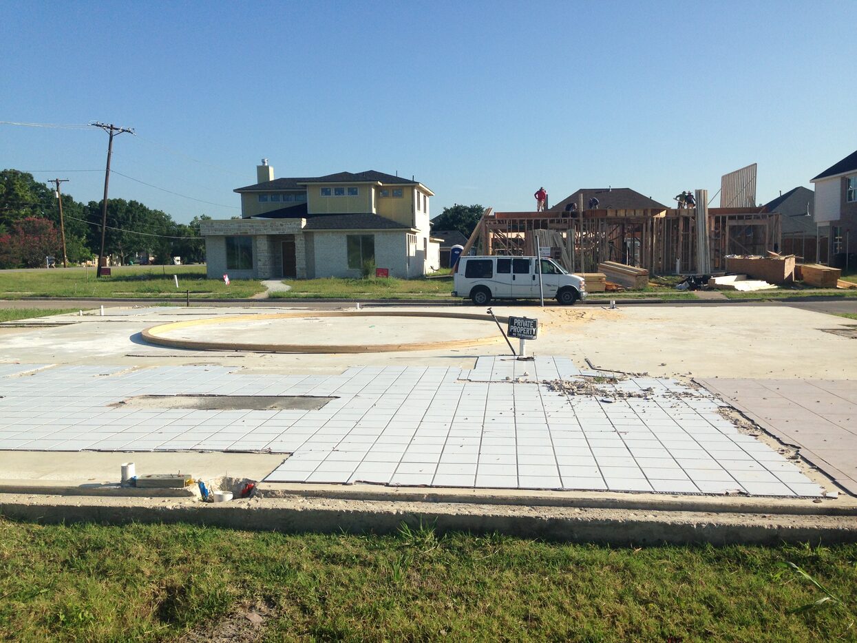 On one side of Lagoon Drive in Rowlett, a slab foundation with tile still attached remains....