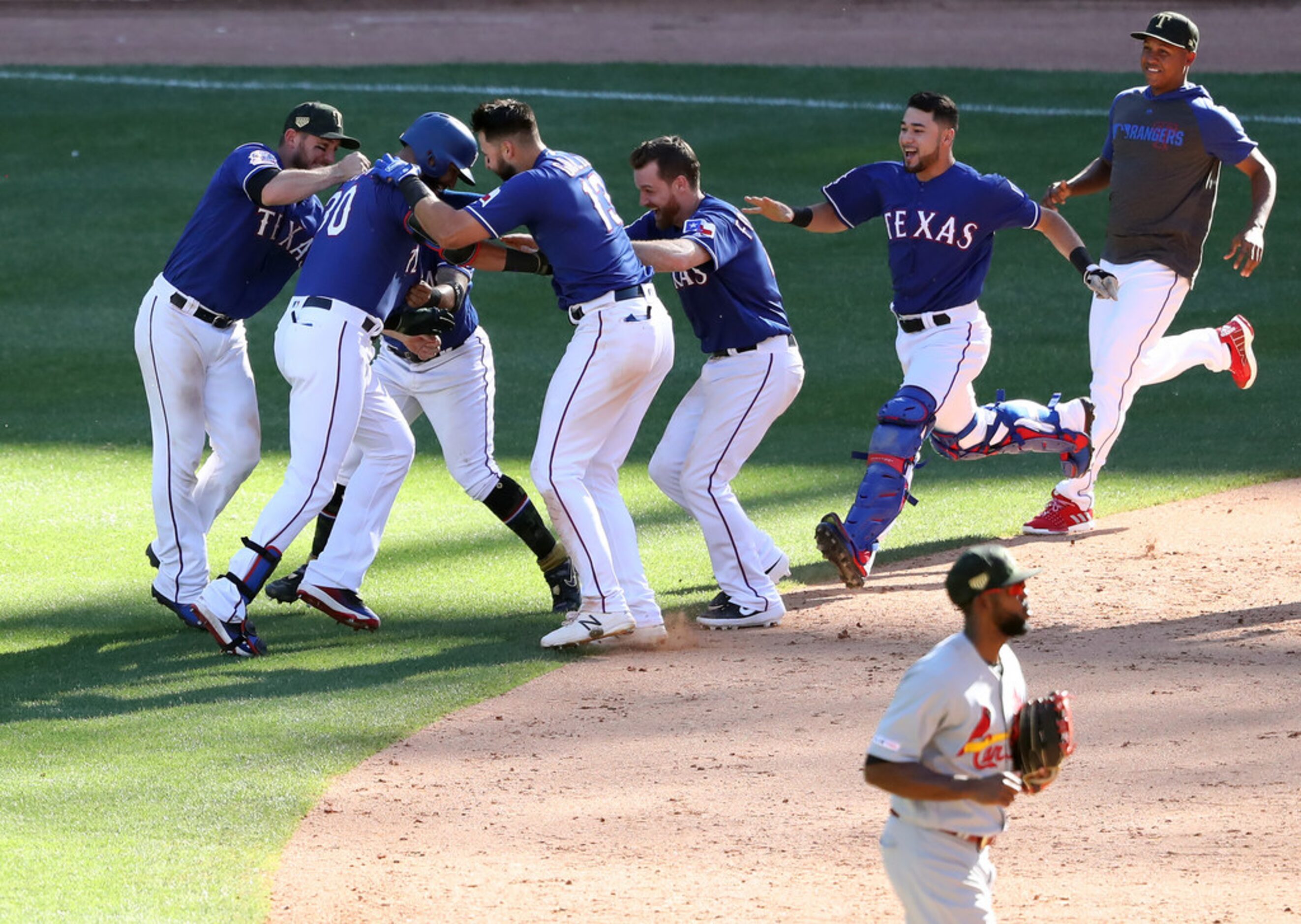 ARLINGTON, TEXAS - MAY 19:  The Texas Rangers celebrate the game winning run scored on a...