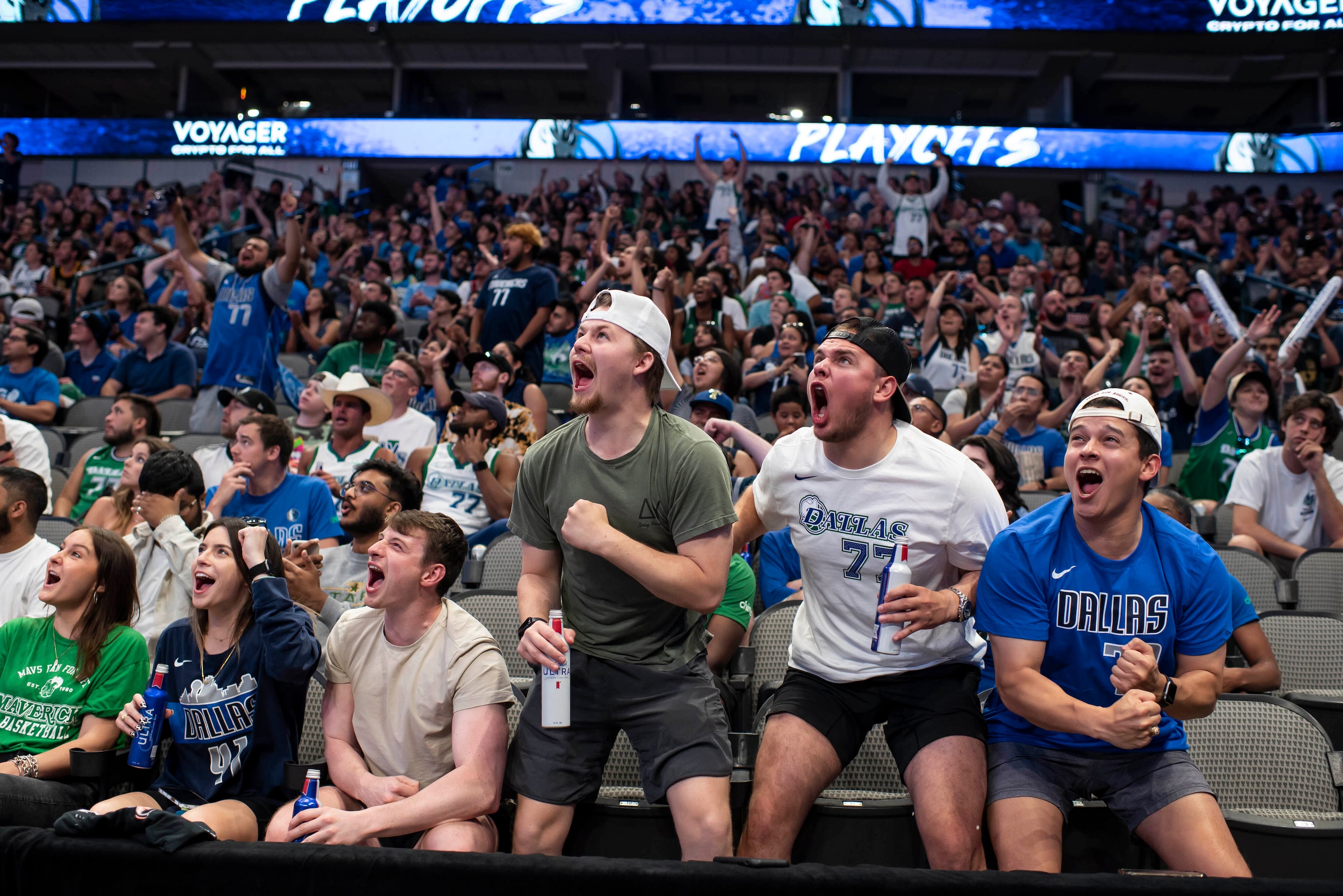 From left, Jake Glaster, Brock Albrecht, and Fili Banda cheer after the Mavericks hit a...