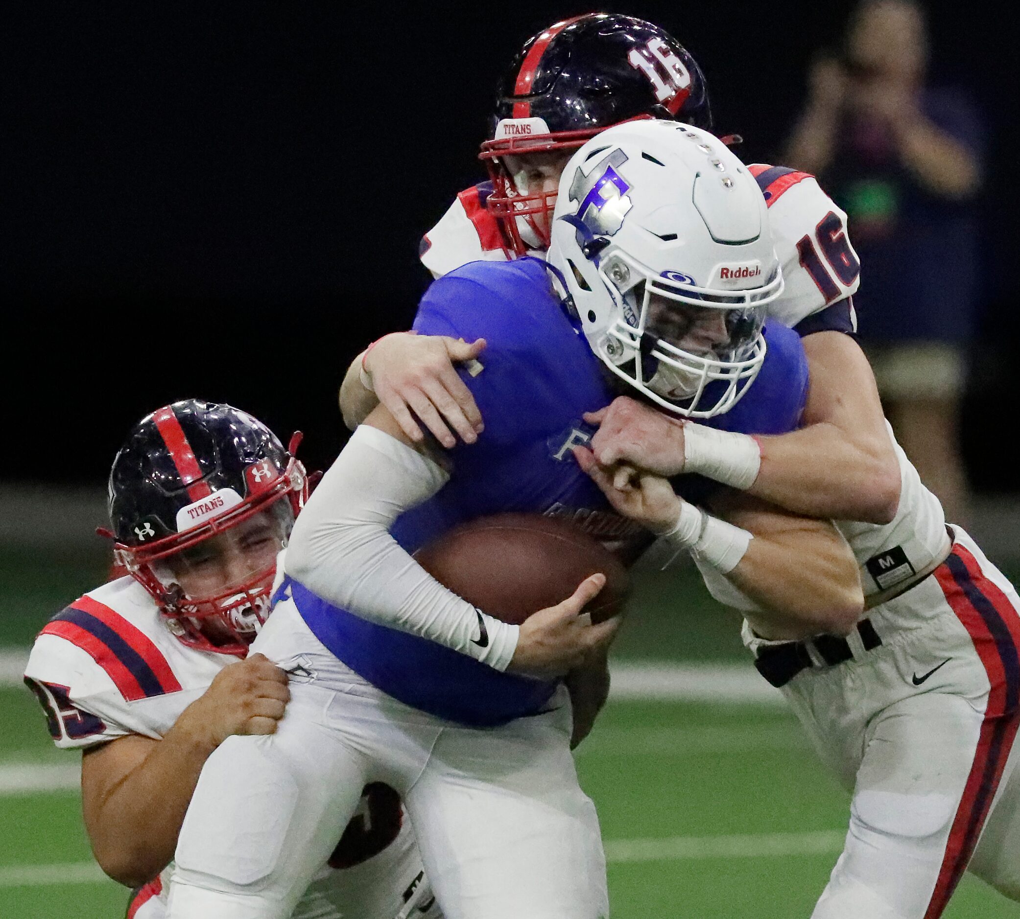 Centennial High School defensive end Jackson Hand (16) and Centennial High School defensive...