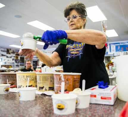 Sylvia Schmidt scoops Blue Bell Ice Cream to serve to customers on Monday, November 2, 2015...
