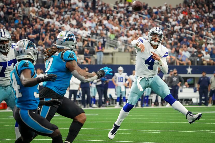 Dallas Cowboys quarterback Dak Prescott (4) makes a throw on the run during the first half...