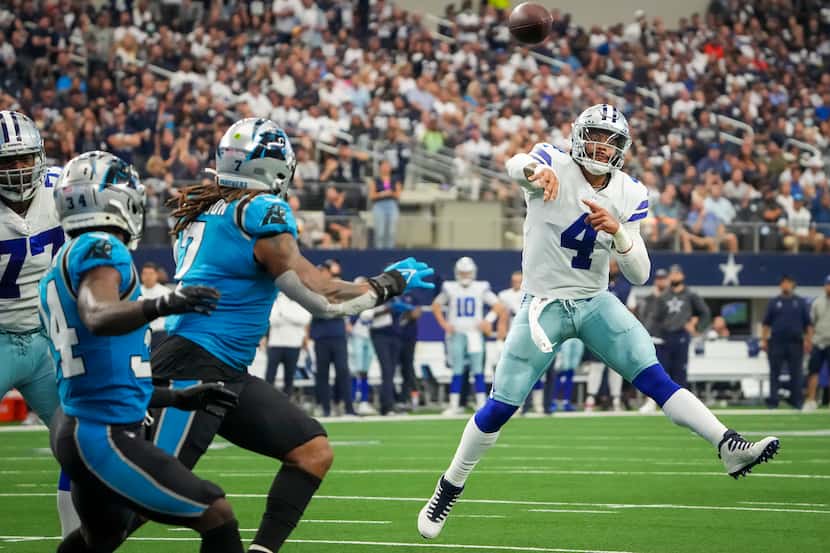 Dallas Cowboys quarterback Dak Prescott makes a throw on the run during the first half of a...