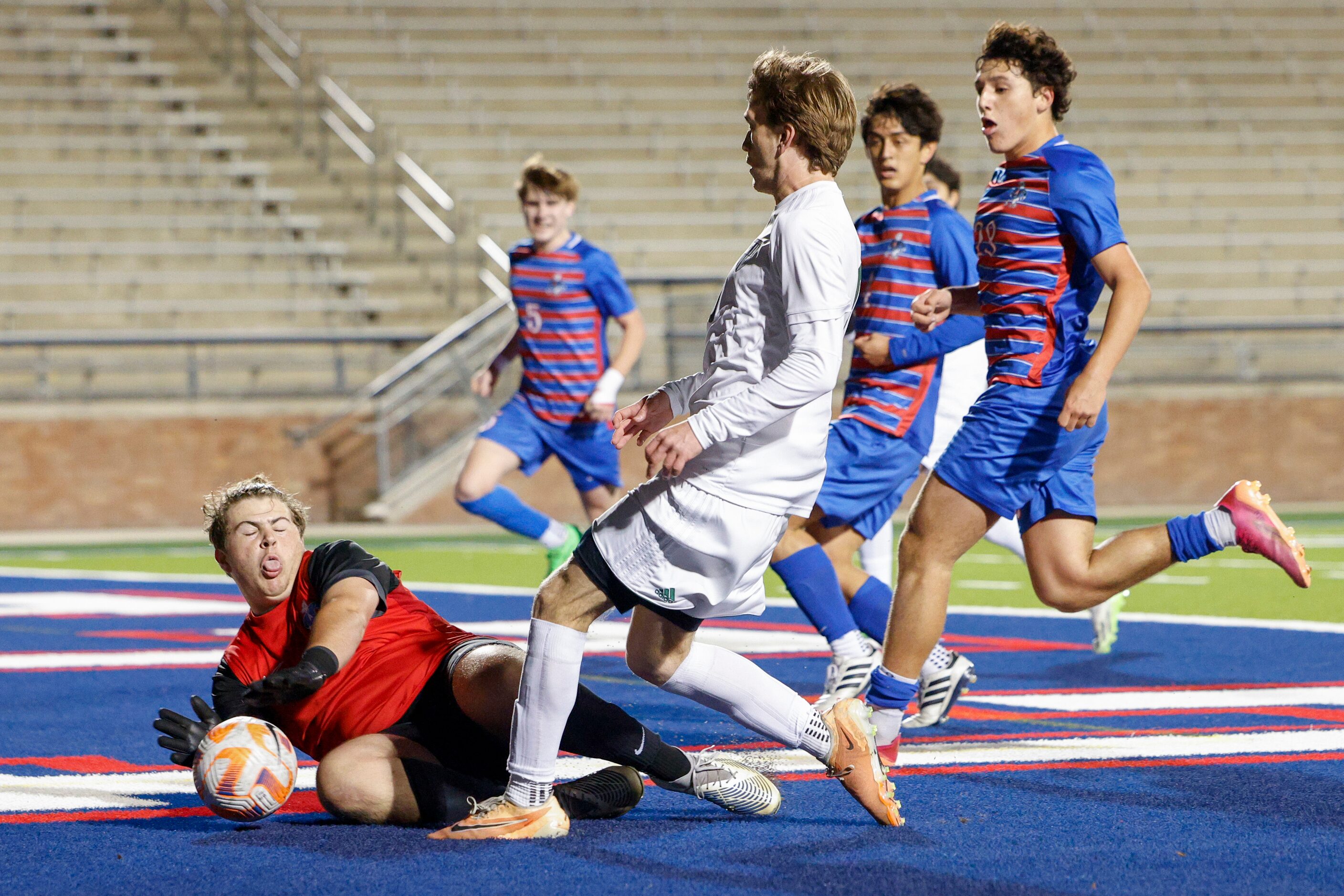 Allen goalkeeper Jackson Dollarhide (0) slides to stop a shot from Prosper’s Caden Berg (10)...