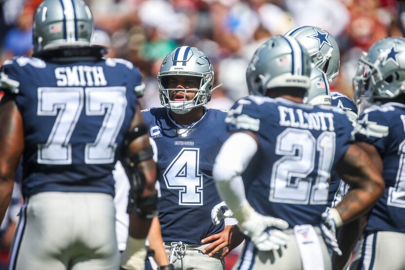 Dallas Cowboys quarterback Dak Prescott (4) chats with his teammates during an NFL game at...