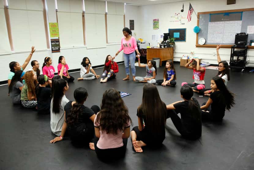 Seventh-graders sit in a circle and share their feelings with dance teacher Alexis Brisby at...